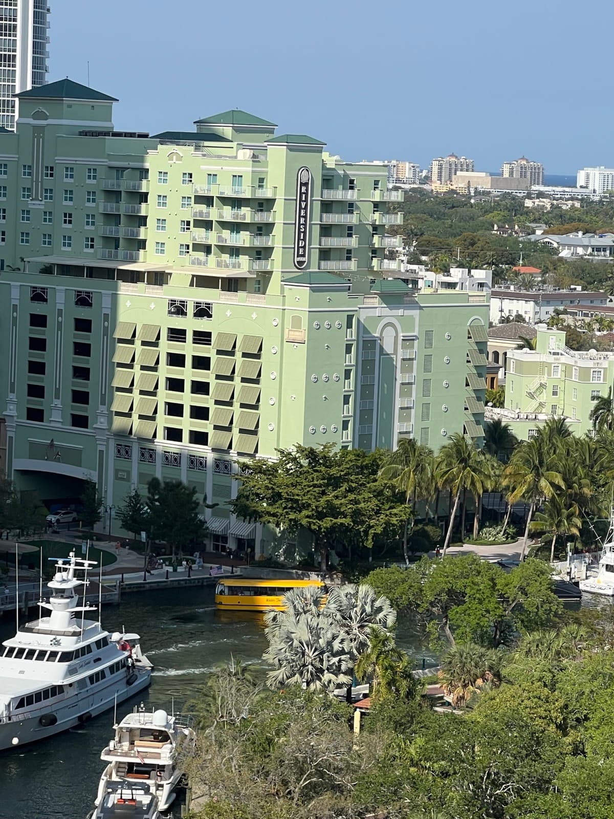 Riverside Hotel green facade across the New River from Las Olas Ave