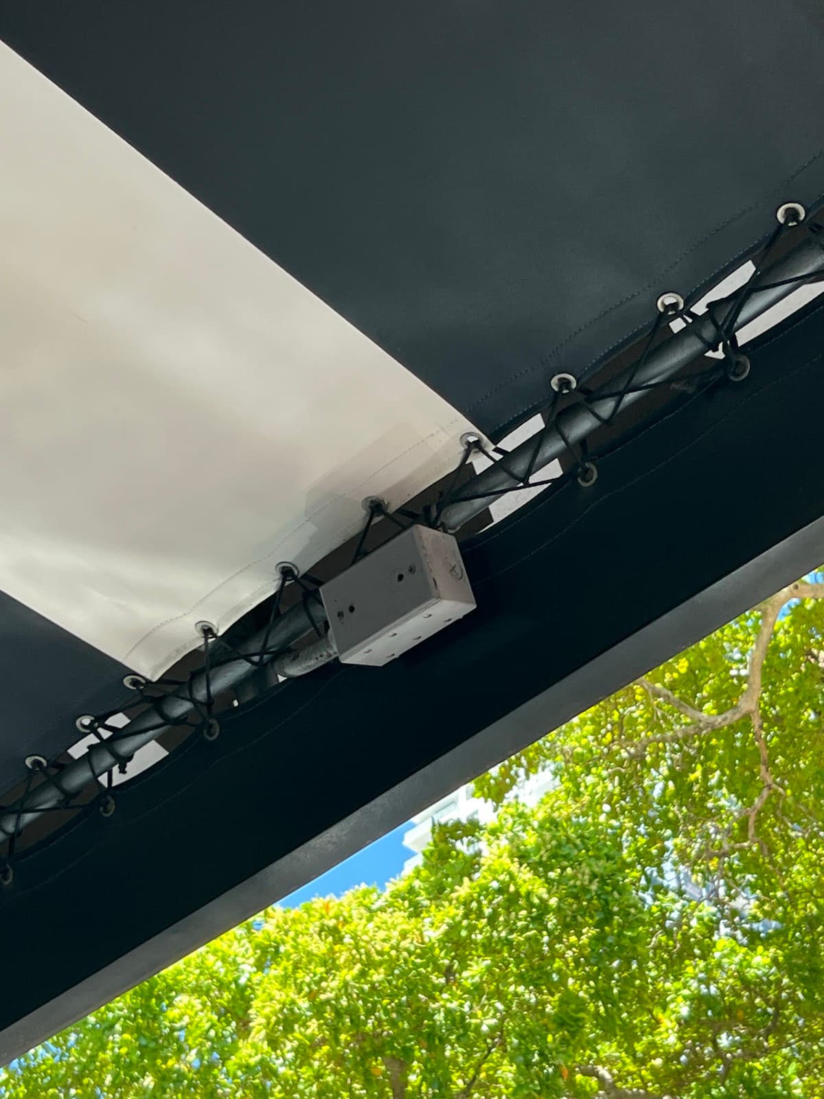 Weather-resistant junction box mounted to the outdoor canopy structure