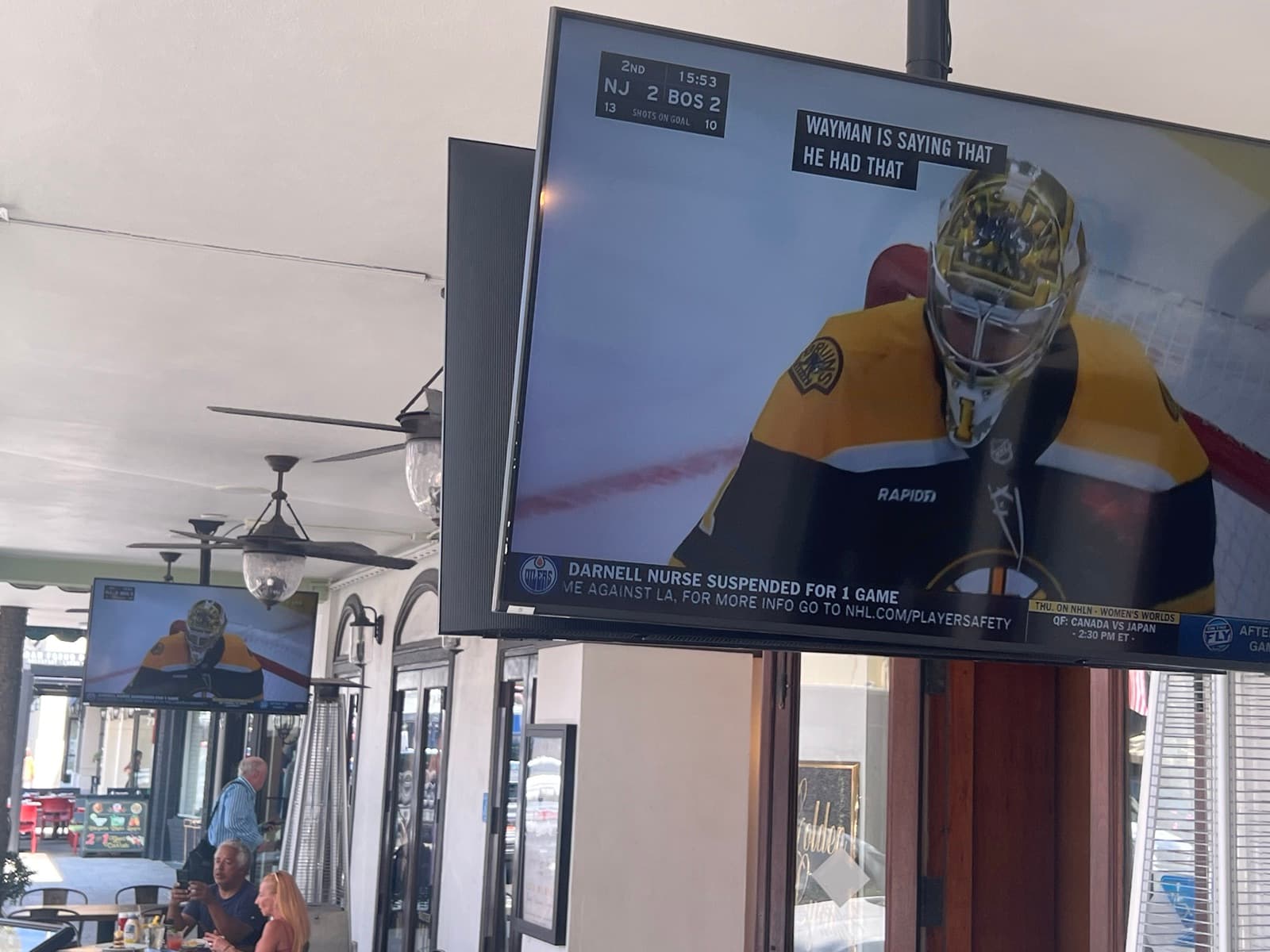 Outdoor commercial display showing live NHL coverage at Wild Sea Oyster Bar
