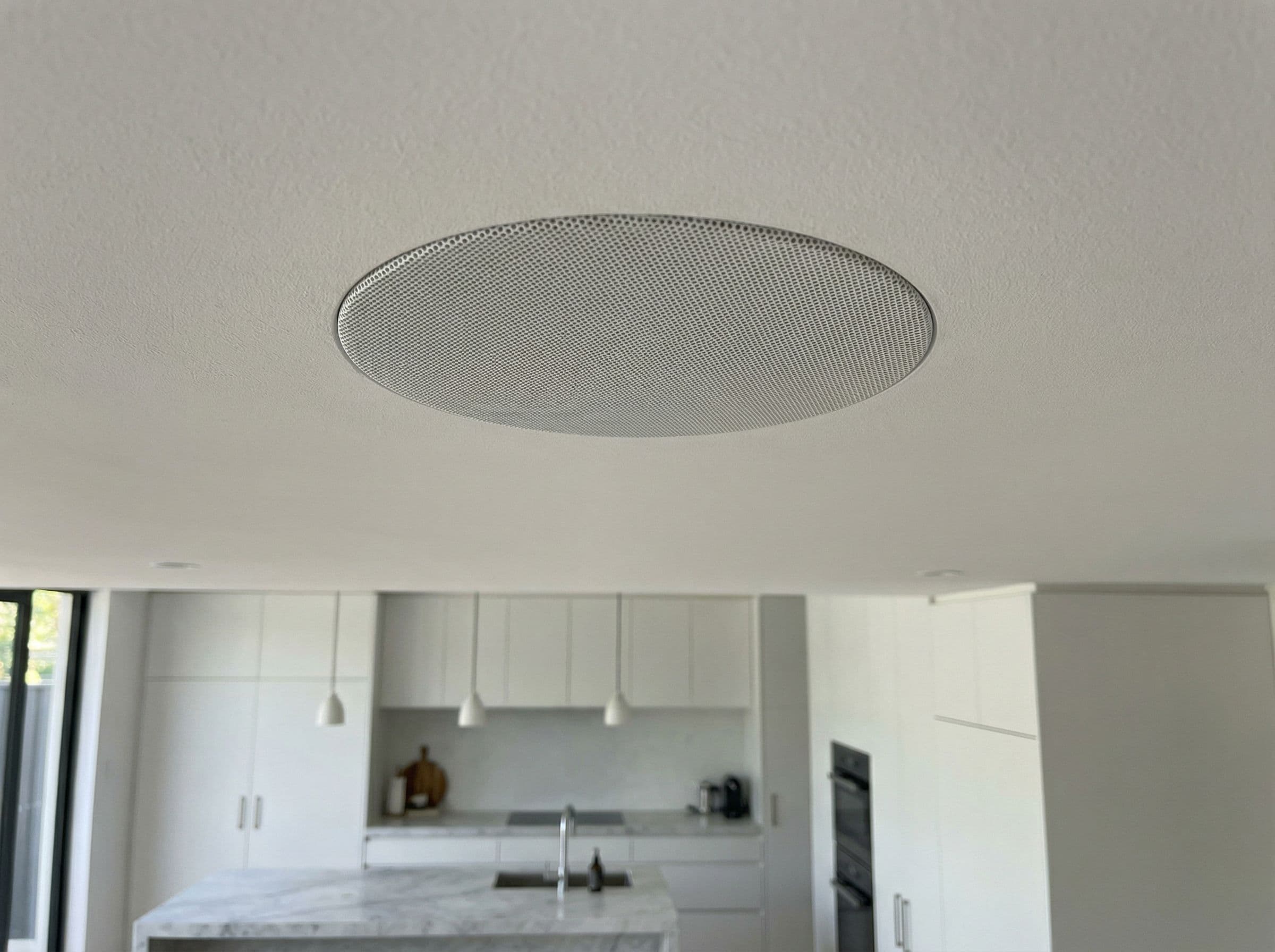 Architectural ceiling speaker in designer kitchen