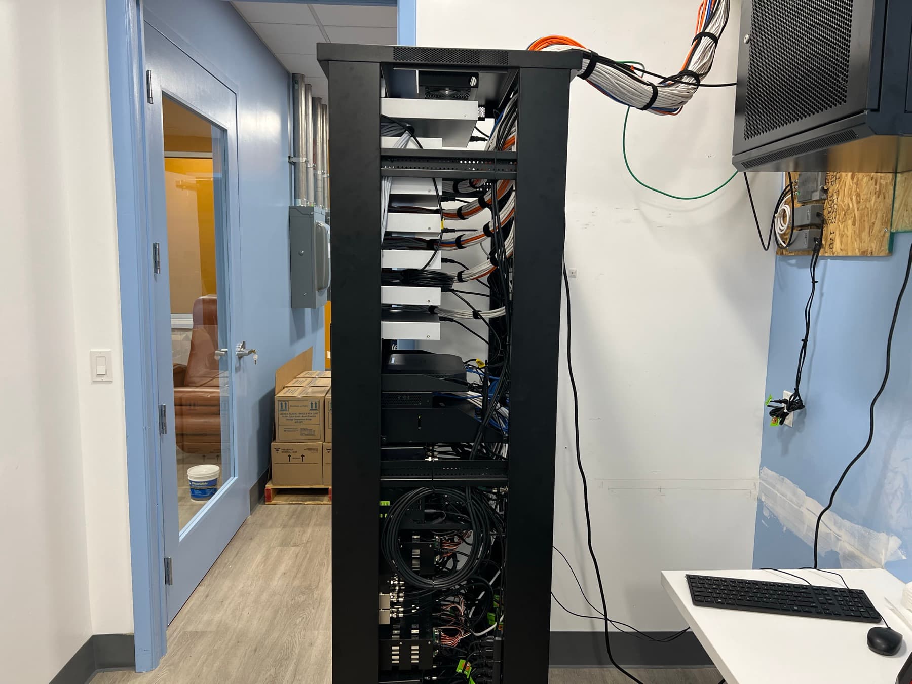 Finished low-voltage rack with organized cable management serving the dialysis facility