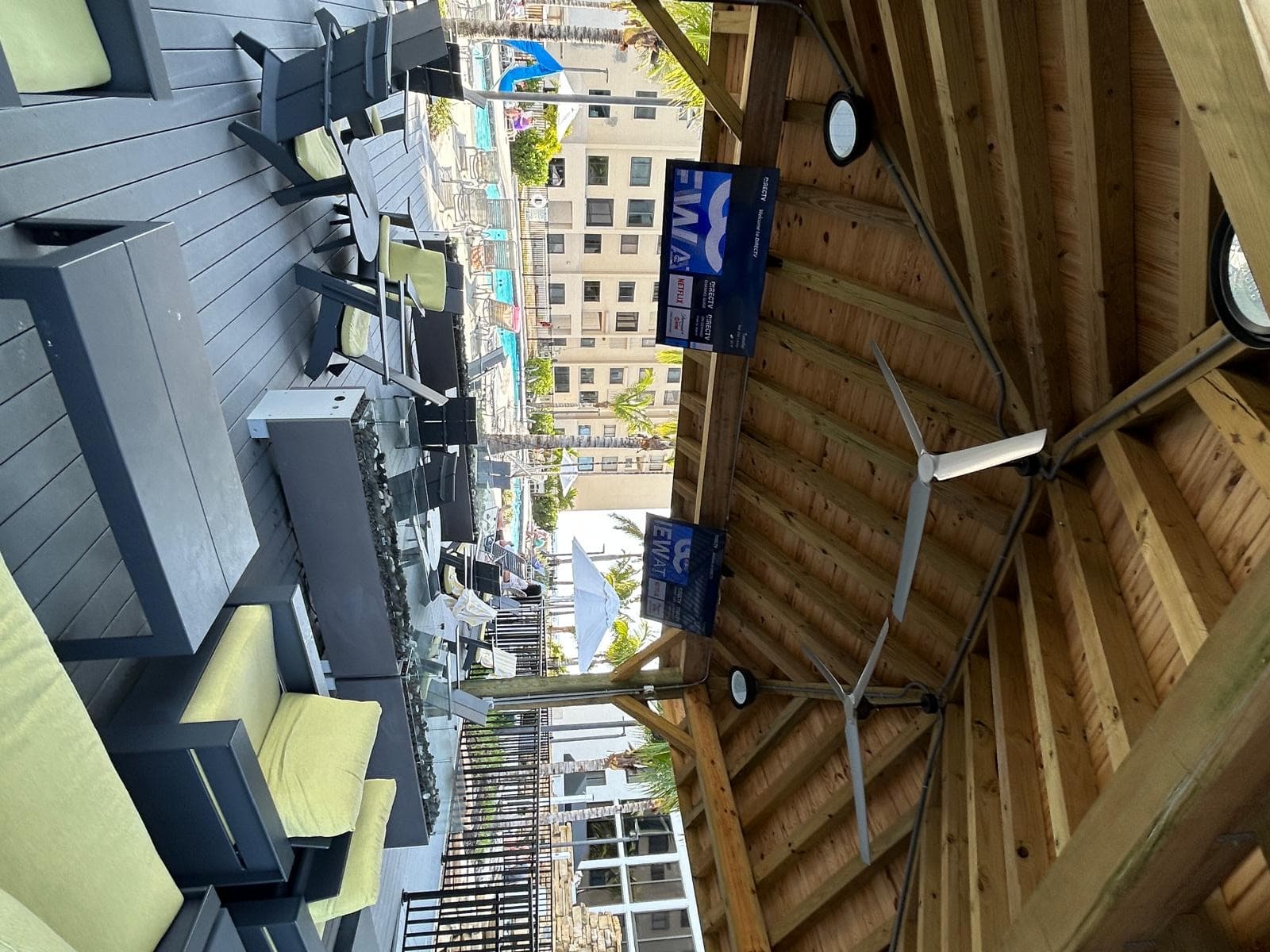 Pool deck pavilion lounge with multi-zone audio and DIRECTV displays in view