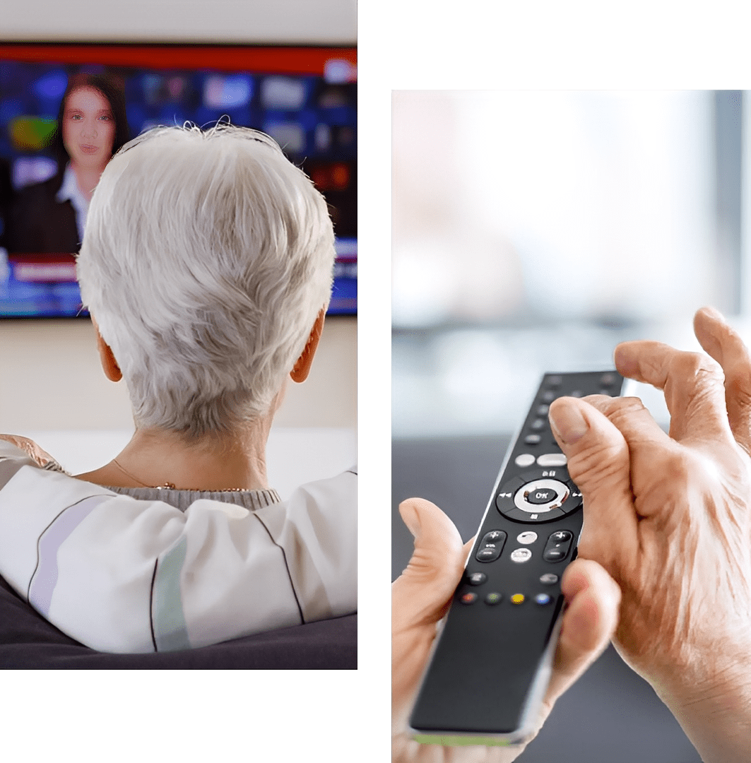 Senior person watching news on TV, holding remote control.