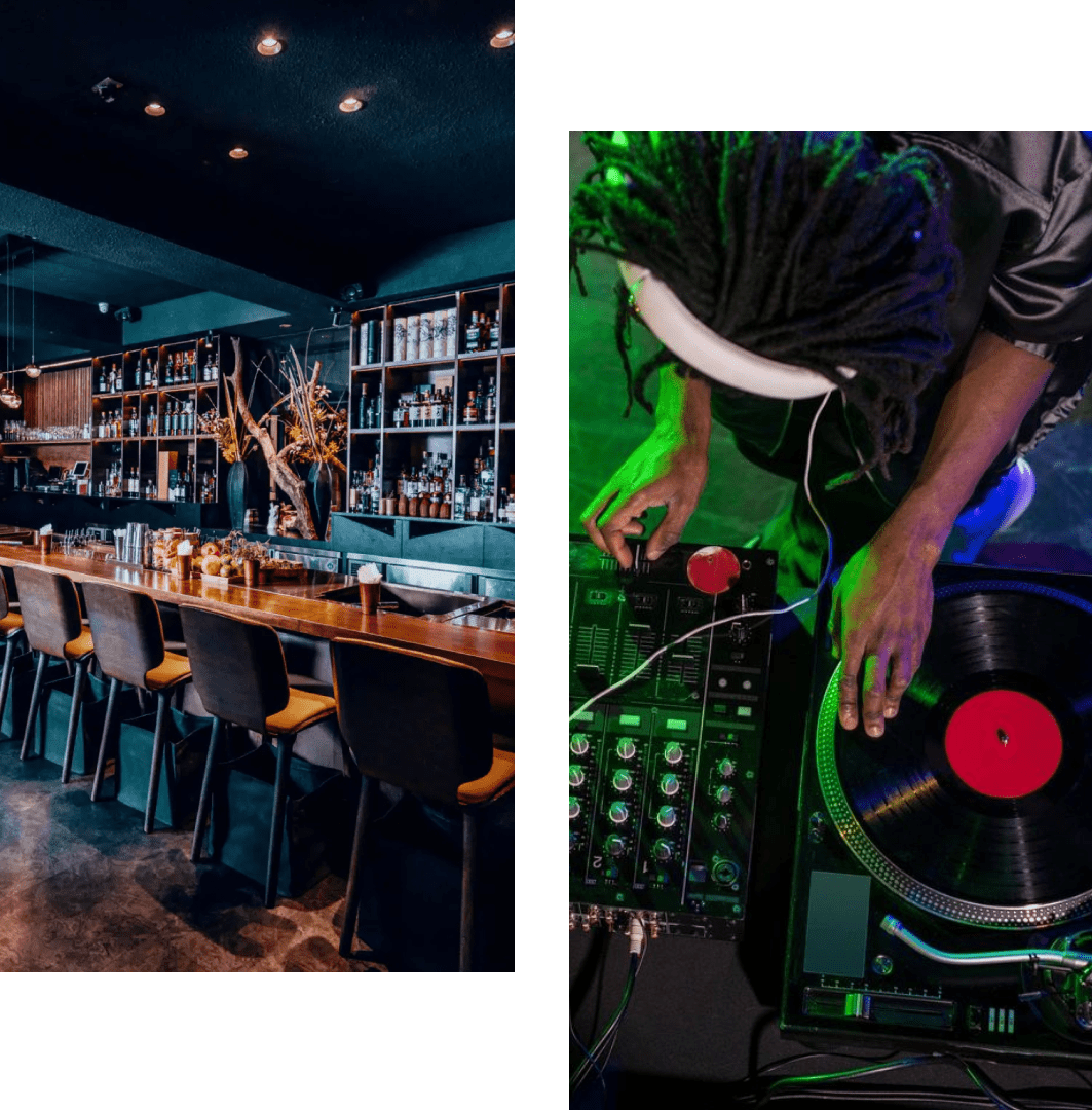 A cozy bar interior and a DJ mixing music on vinyl turntables.