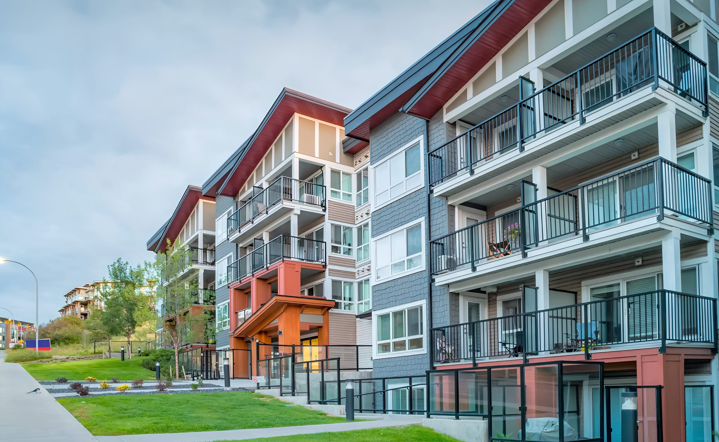 Modern apartment buildings with balconies on a clear day.